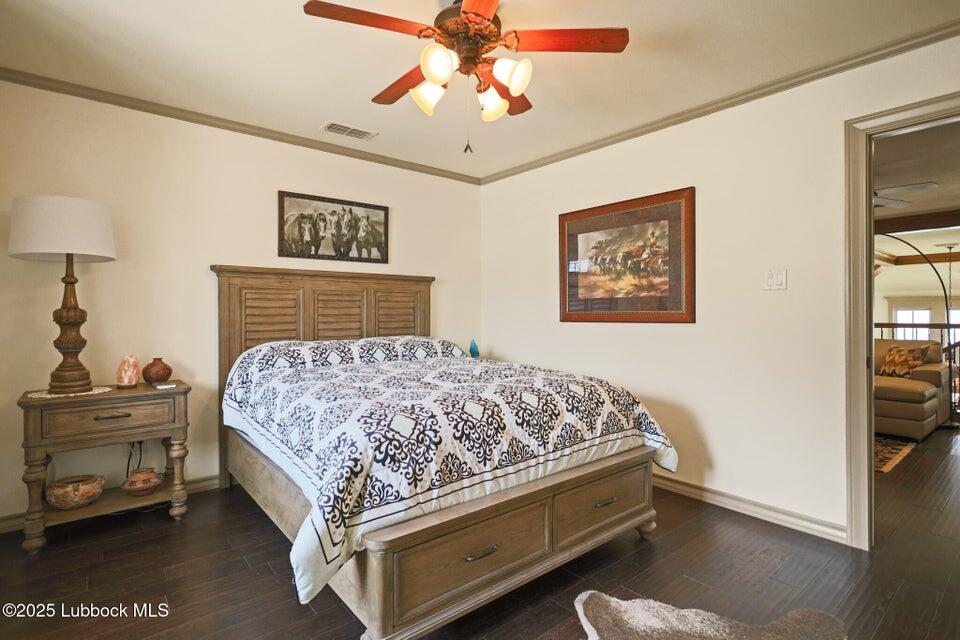 4501 19th Street, Unit 6 Lubbock, TX 79407 - Photo 32 of 44 a bedroom with a bed and a chandelier
