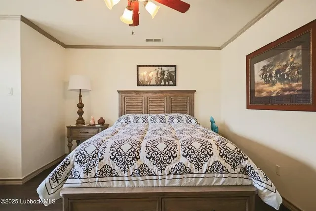 a bedroom with a bed and a chandelier