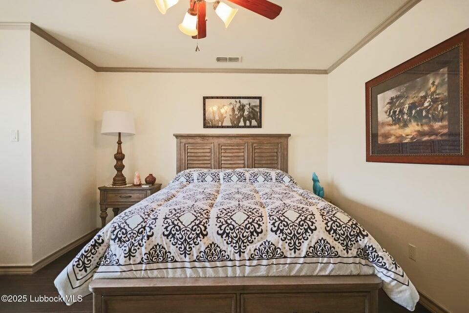 4501 19th Street, Unit 6 Lubbock, TX 79407 - Photo 33 of 44 a bedroom with a bed and a chandelier