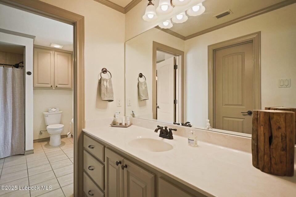 4501 19th Street, Unit 6 Lubbock, TX 79407 - Photo 37 of 44 a bathroom with a double vanity sink mirror and toilet