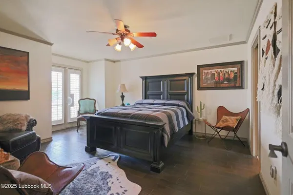 a spacious bedroom with a bed and wooden floor