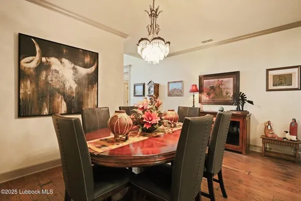a dining room with furniture and wooden floor