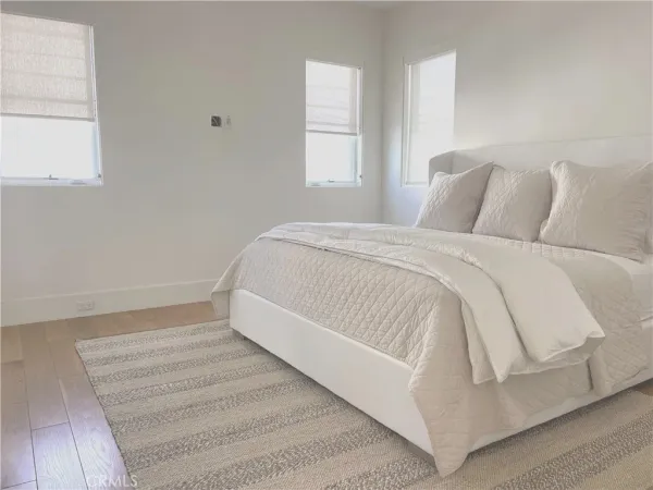 a bed sitting in a bedroom next to a window