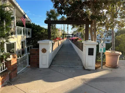 a view of a house with a yard and palm trees