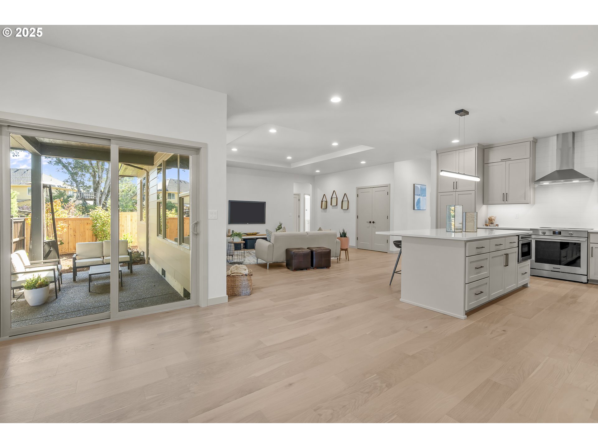 955 Oak Meadows Place Springfield, OR 97477 - Photo 14 of 37 a large white kitchen with stainless steel appliances kitchen island granite countertop a large counter top and a stove