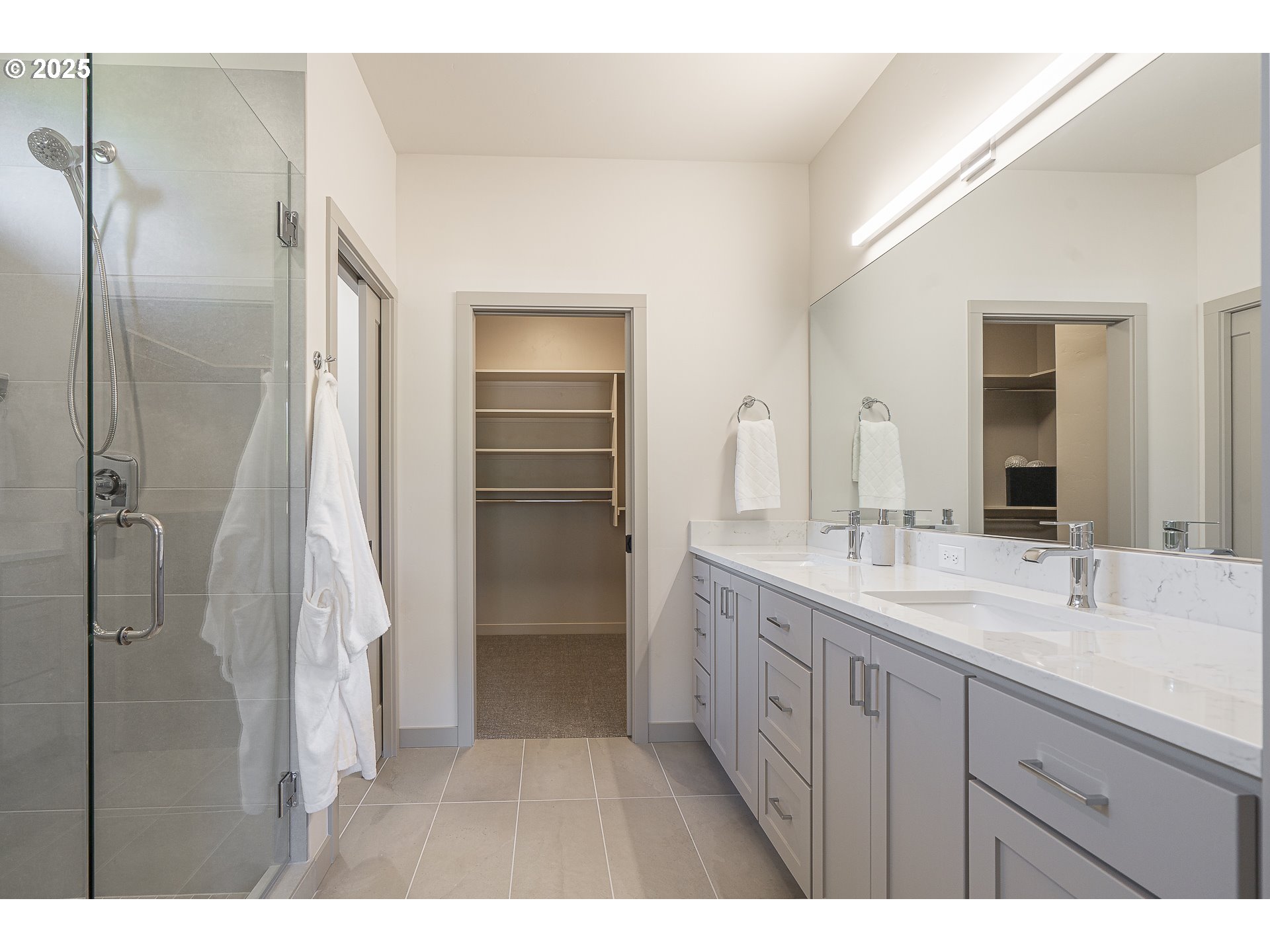 955 Oak Meadows Place Springfield, OR 97477 - Photo 21 of 37 a bathroom with a double vanity sink a mirror and a shower