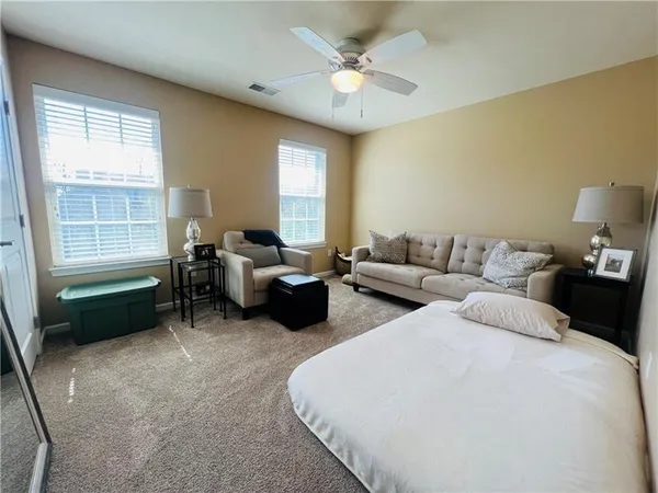 a bedroom with bed and a window