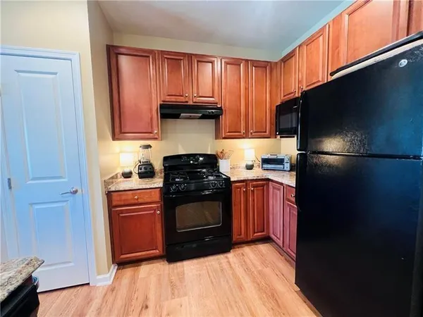 a kitchen with stainless steel appliances granite countertop a refrigerator stove and sink
