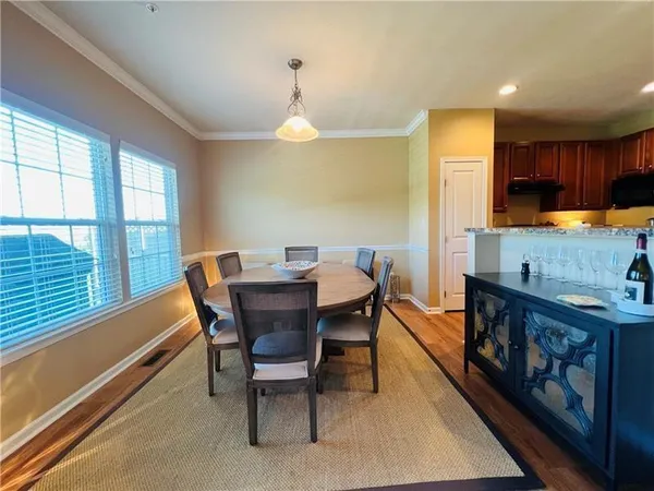 a view of a dining room with furniture window and wooden floor