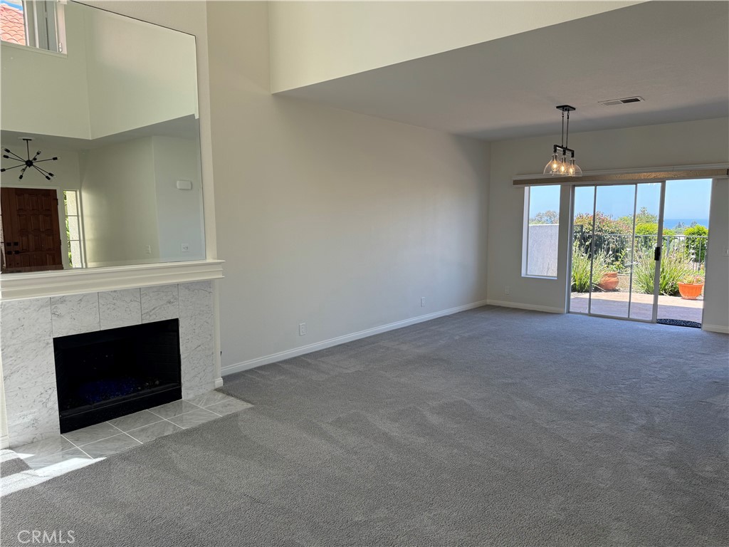 25 St Kitts Dana Point, CA 92629 - Photo 5 of 14 an empty room with windows and fireplace