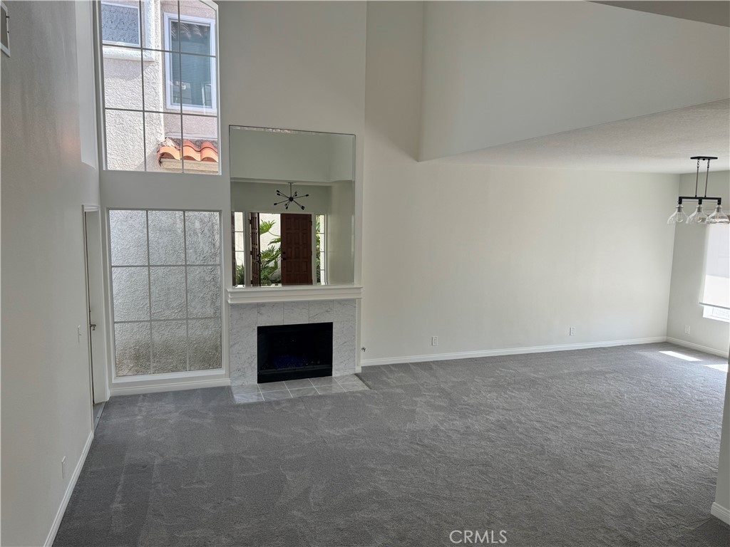 25 St Kitts Dana Point, CA 92629 - Photo 6 of 14 an empty room with fireplace and windows