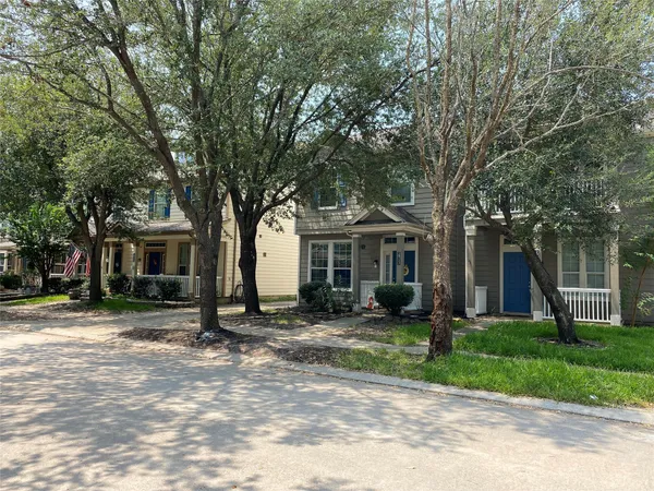 a front view of a house with a tree