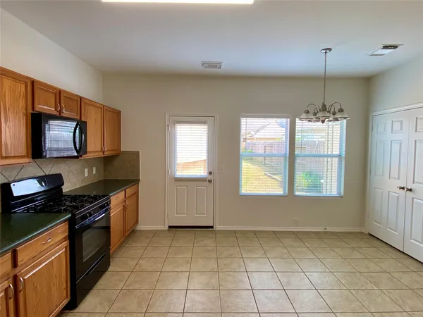 a kitchen with a stove a sink and a microwave