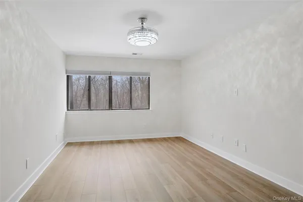 a view of wooden floor and chandelier in a room