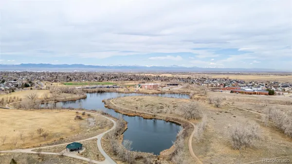 an aerial view of a house with a yard and lake view