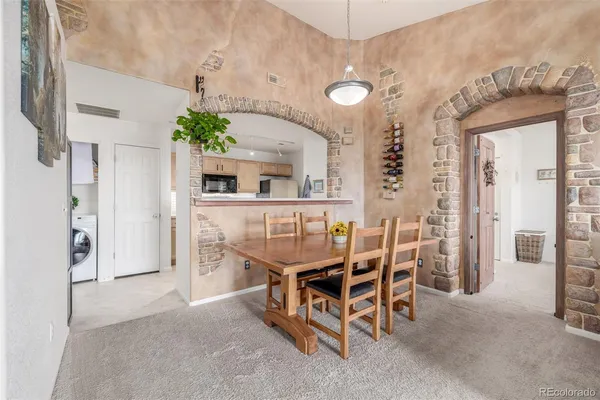 a dining room with furniture and window