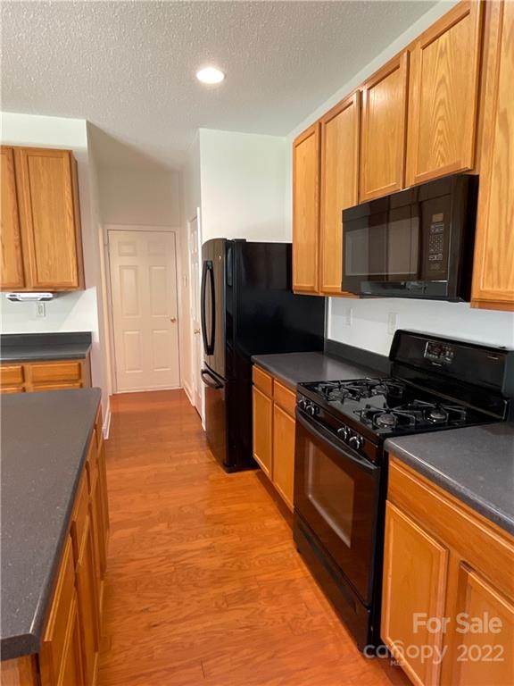 13712 Rutherglen Court Charlotte, NC 28213 - Photo 11 of 22 a kitchen with stainless steel appliances granite countertop a stove a refrigerator and a microwave