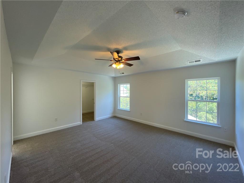 13712 Rutherglen Court Charlotte, NC 28213 - Photo 12 of 22 an empty room with windows and fan