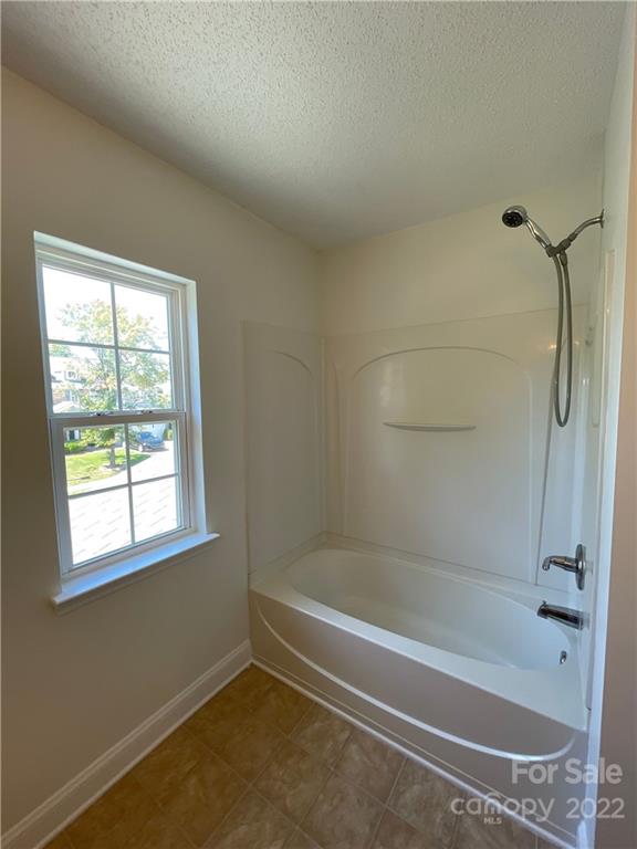 13712 Rutherglen Court Charlotte, NC 28213 - Photo 17 of 22 a bathroom with a bathtub and a shower