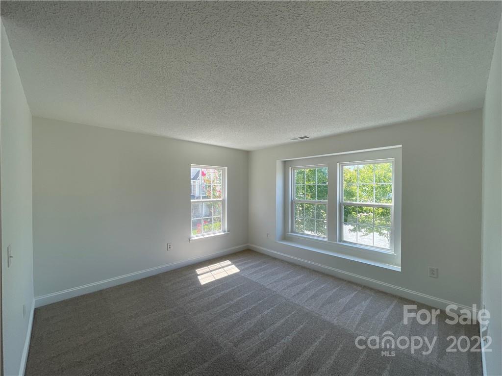 13712 Rutherglen Court Charlotte, NC 28213 - Photo 19 of 22 an empty room with wooden floor and windows