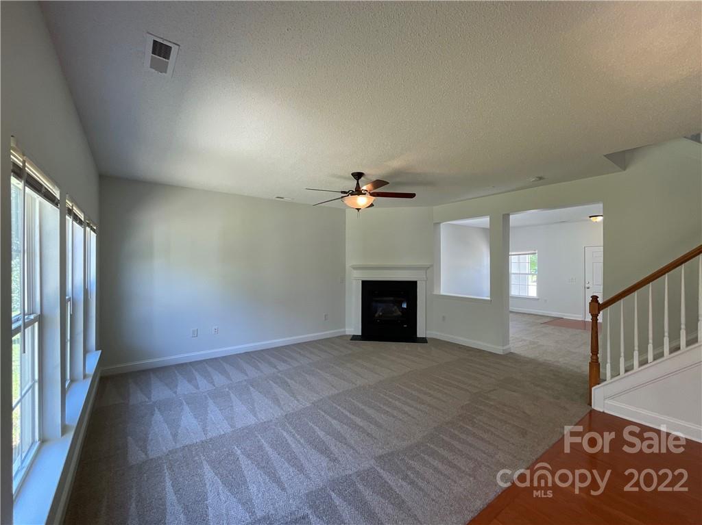 13712 Rutherglen Court Charlotte, NC 28213 - Photo 4 of 22 wooden floor in an empty room with a fireplace