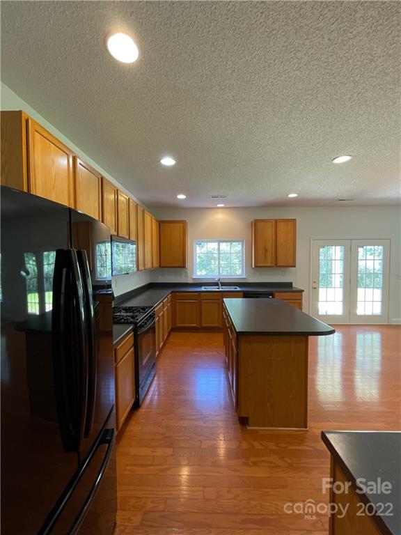 13712 Rutherglen Court Charlotte, NC 28213 - Photo 9 of 22 a kitchen with stainless steel appliances granite countertop a stove a sink and a refrigerator