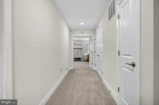a view of a hallway with wooden shelves