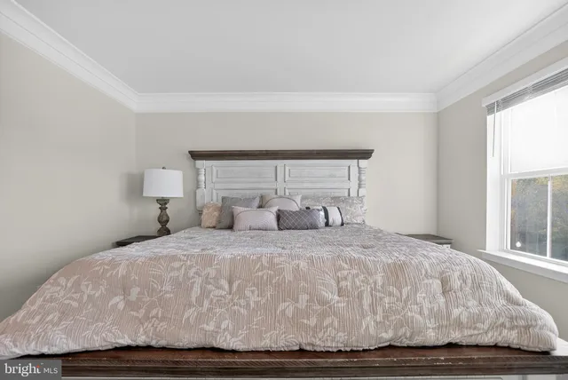 a bedroom with a bed and window