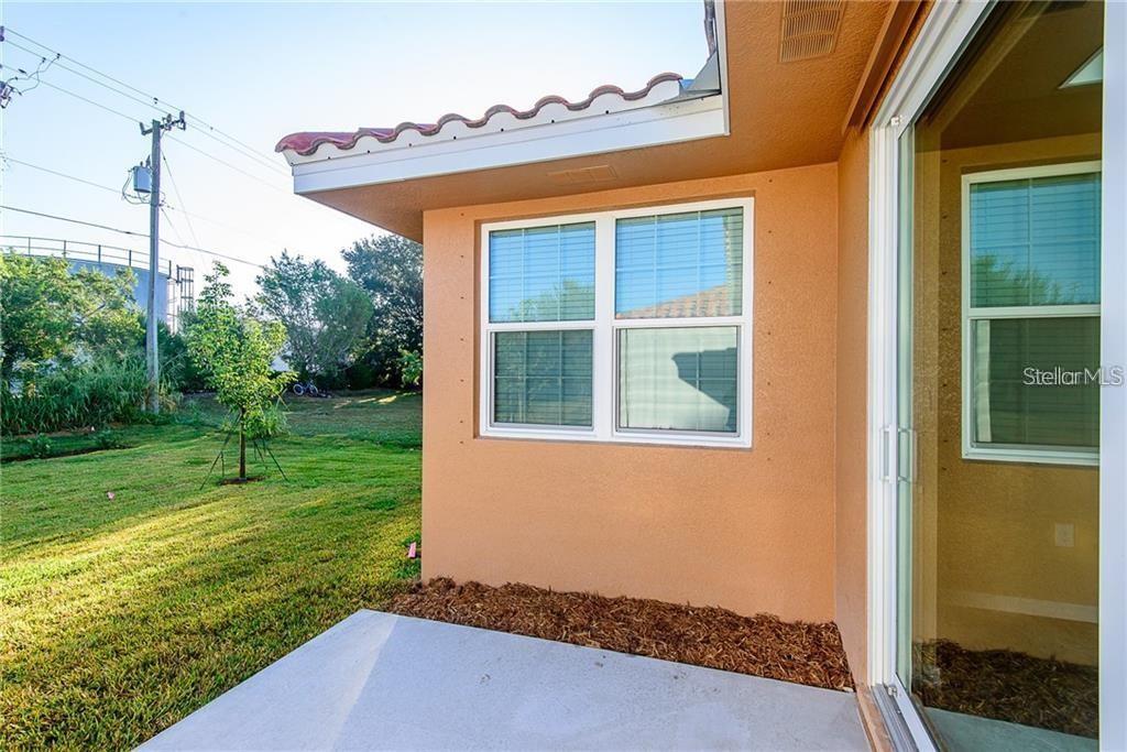 3948 San Rocco Drive, Unit 112 Punta Gorda, FL 33950 - Photo 18 of 18 a front view of a house with garden