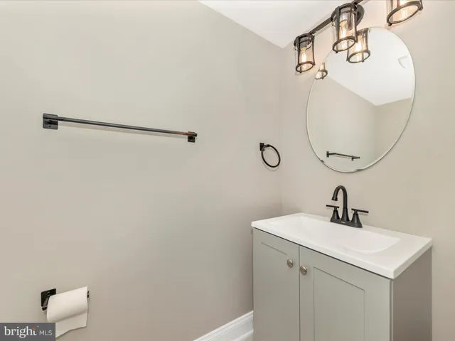 a bathroom with a sink and mirror