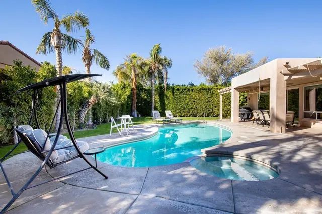a view of a patio with a table chairs and a patio