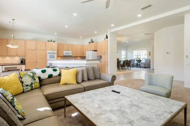 a living room with furniture and kitchen view