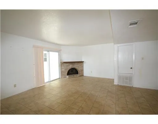 a view of empty room with a fireplace