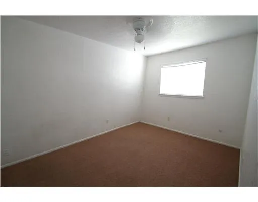 a view of an empty room and a window