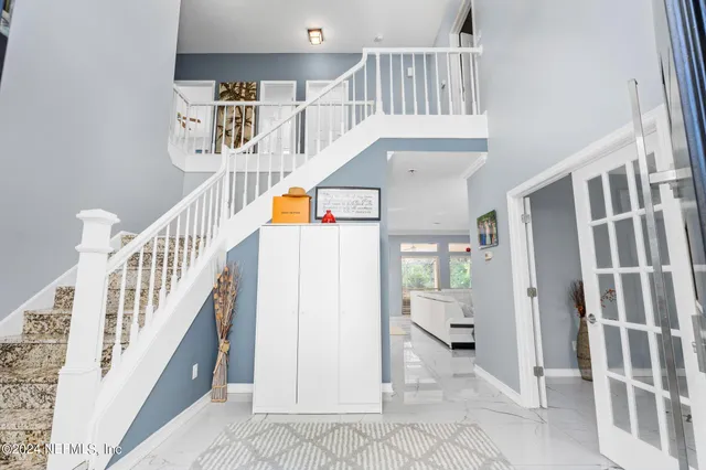 a view of hallway with stairs and a wooden floor