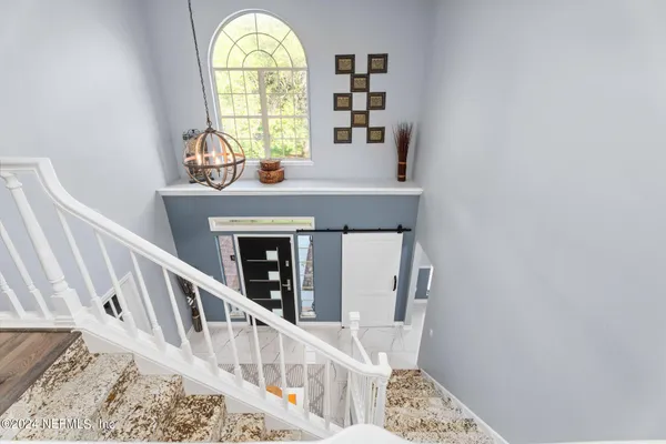 a view of an entryway with wooden floor