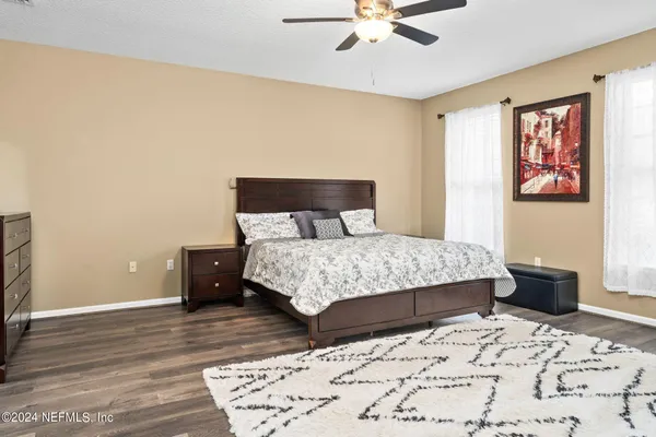 a bedroom with a bed and wooden floor