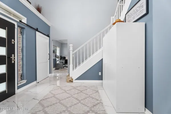 a view of entryway and hall with wooden floor