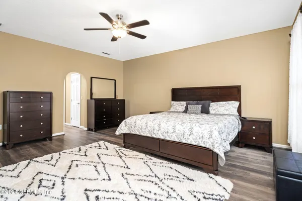 a bedroom with a bed and a dresser