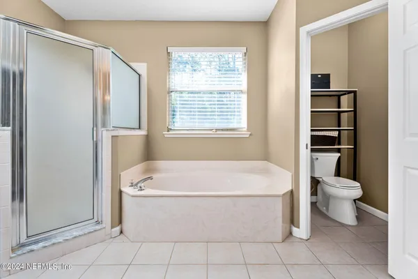 a white bath tub sitting next to a white toilet