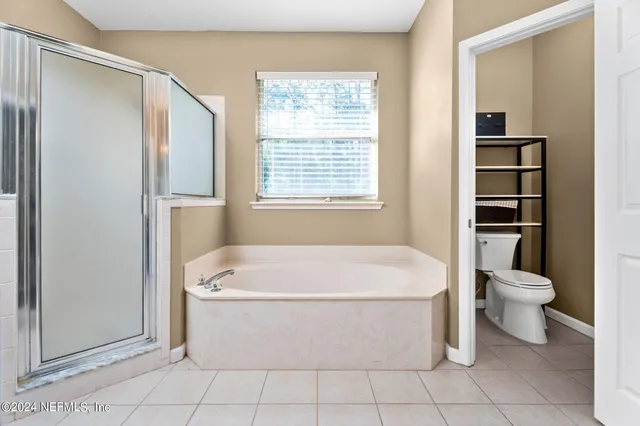 a white bath tub sitting next to a white toilet