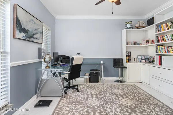 a workspace with furniture and a book shelf