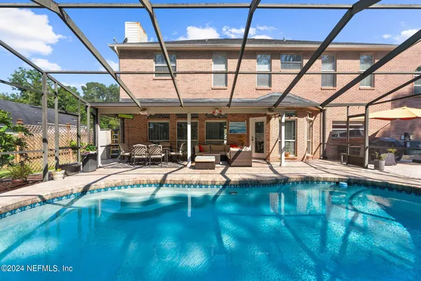 a view of swimming pool with outdoor seating
