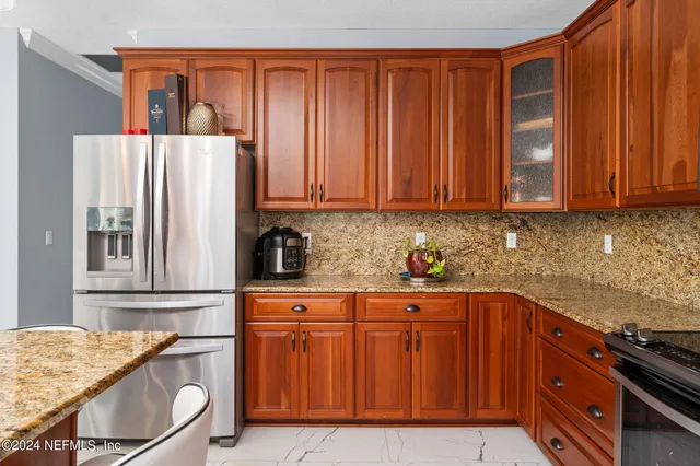 a kitchen with stainless steel appliances granite countertop wooden cabinets a sink and dishwasher
