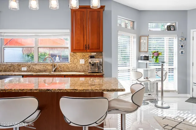 a kitchen with a table chairs and a window