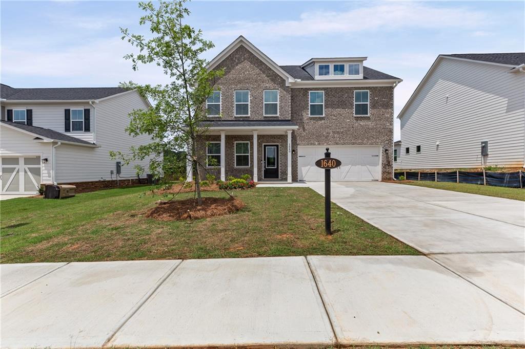 1640 Tide Ml Road Cumming, GA 30040 - Photo 1 of 1 a front view of a house with a yard