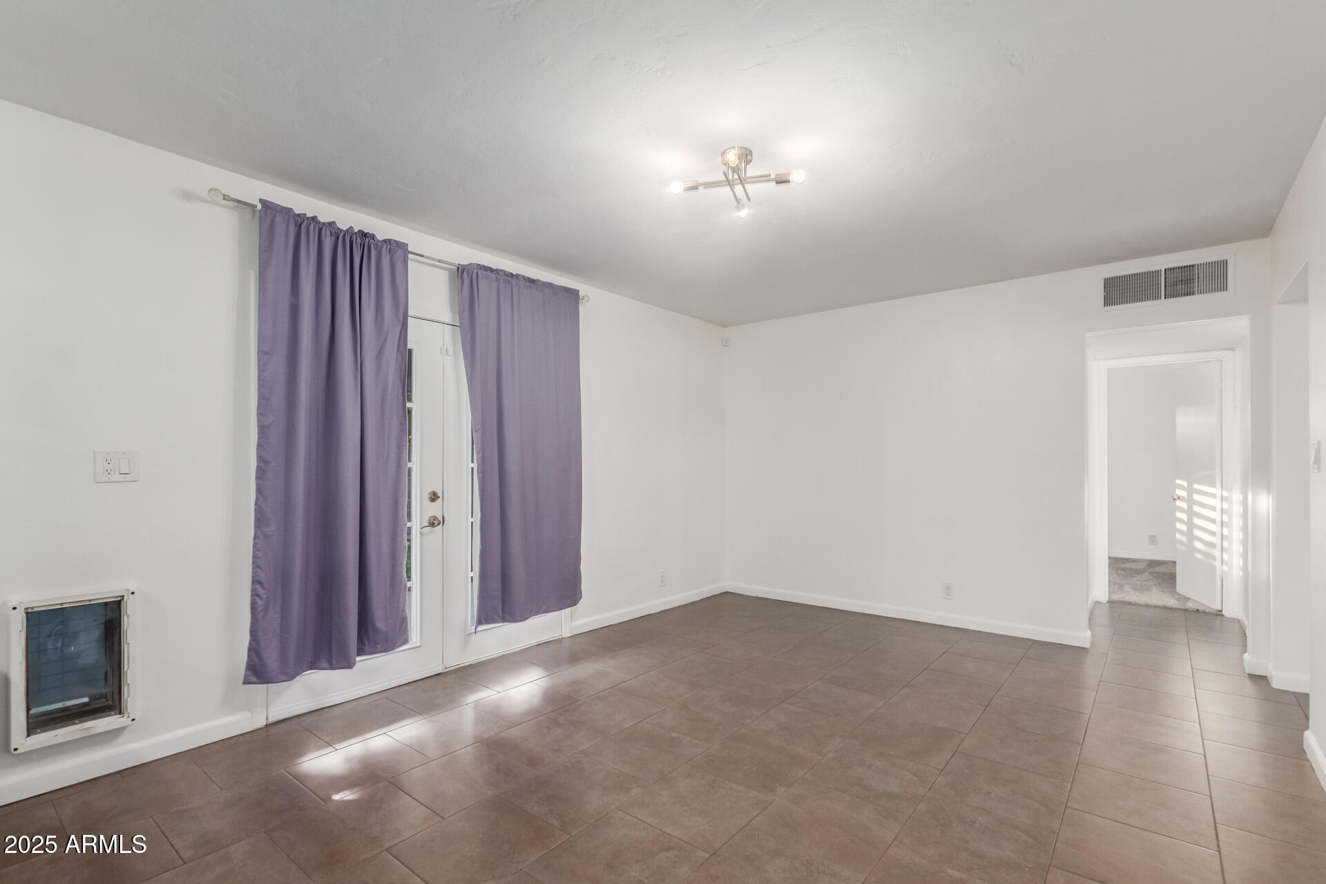 8912 North 17th Avenue Phoenix, AZ 85021 - Photo 11 of 33 a view of an empty room with wooden floor