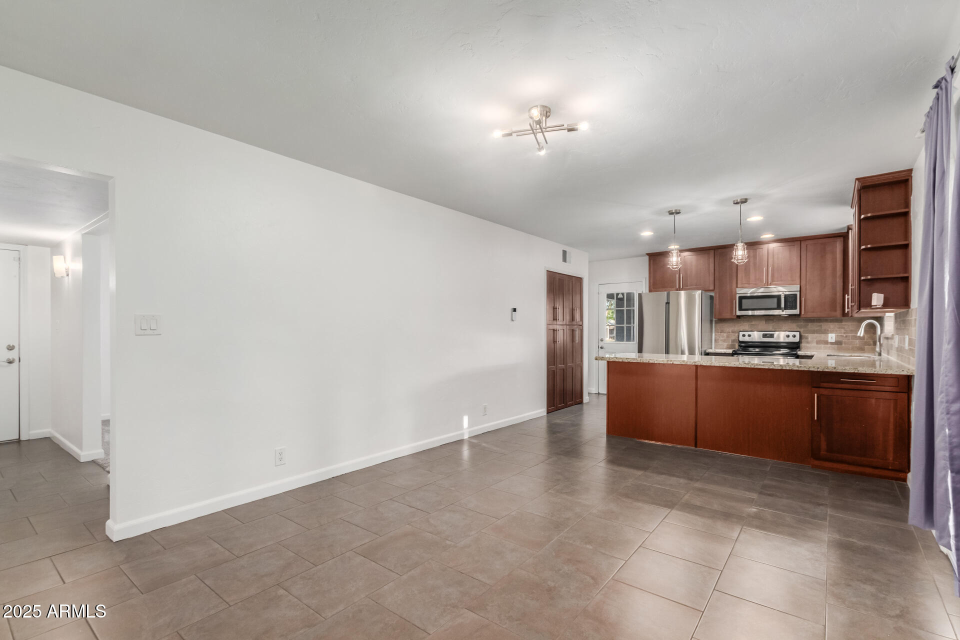 8912 North 17th Avenue Phoenix, AZ 85021 - Photo 12 of 33 a large kitchen with cabinets and stainless steel appliances