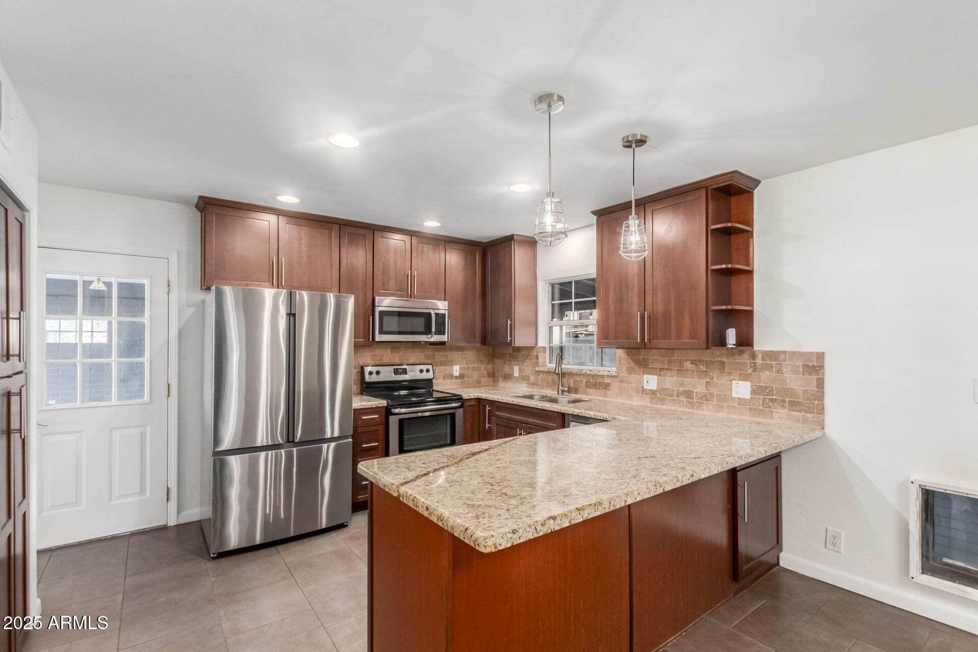 8912 North 17th Avenue Phoenix, AZ 85021 - Photo 13 of 33 a kitchen with stainless steel appliances granite countertop a sink stove and refrigerator