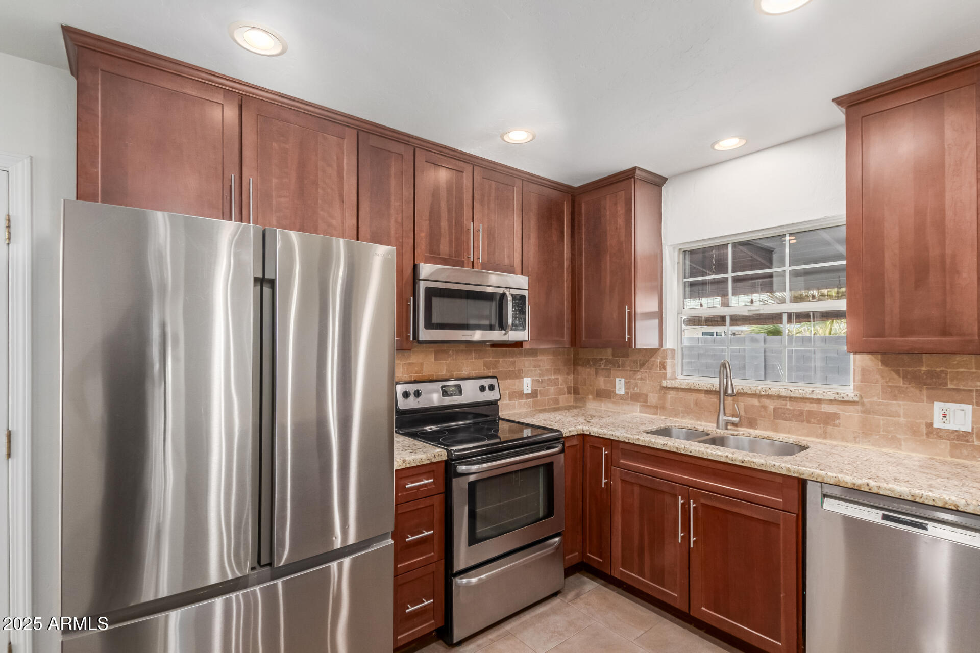 8912 North 17th Avenue Phoenix, AZ 85021 - Photo 14 of 33 a kitchen with granite countertop stainless steel appliances and refrigerator